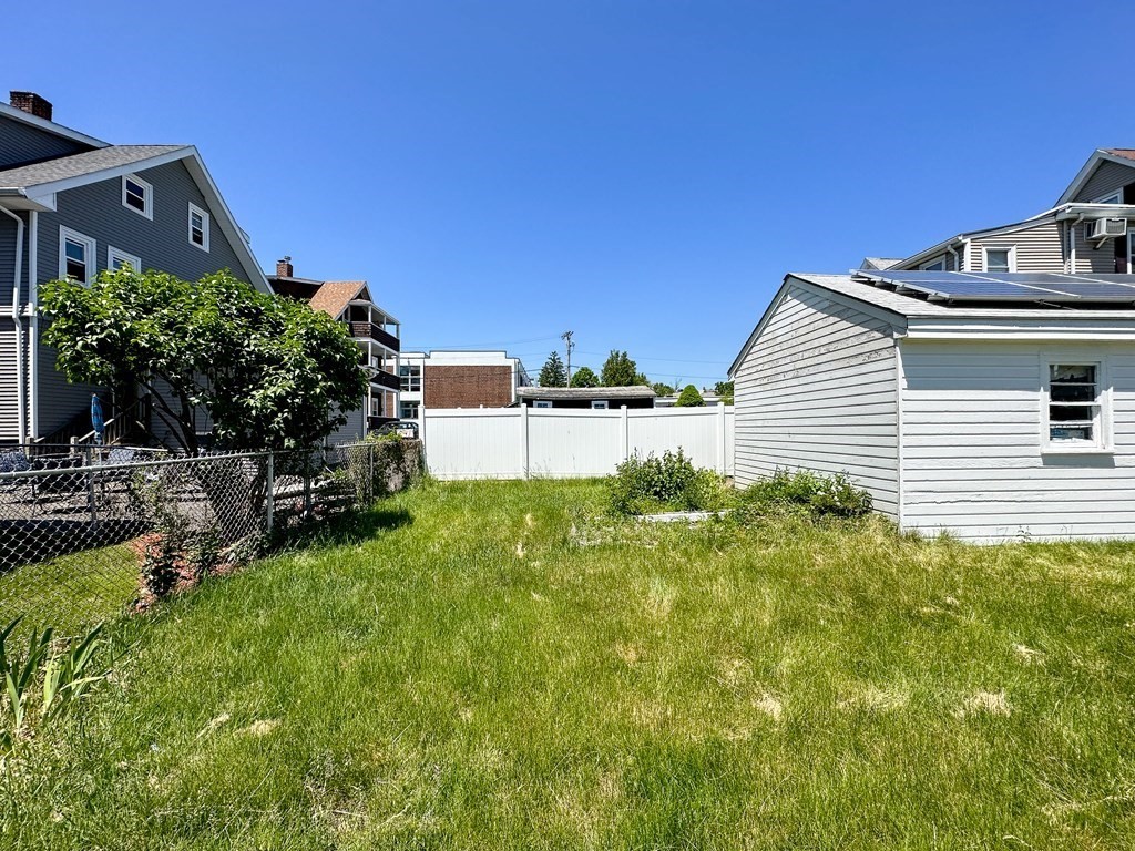 82 Jefferson Avenue Everett, MA 02149 - Photo 37 of 37 a view of a house with a backyard and a garden