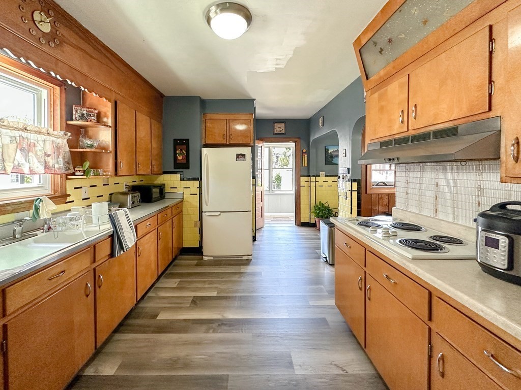 82 Jefferson Avenue Everett, MA 02149 - Photo 4 of 37 a kitchen with sink a stove and refrigerator