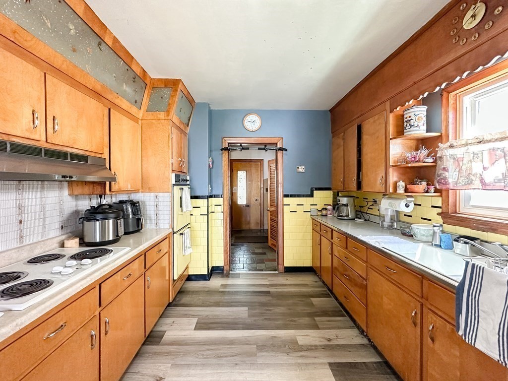 82 Jefferson Avenue Everett, MA 02149 - Photo 5 of 37 a large kitchen with stainless steel appliances granite countertop lots of counter top space and wooden floor
