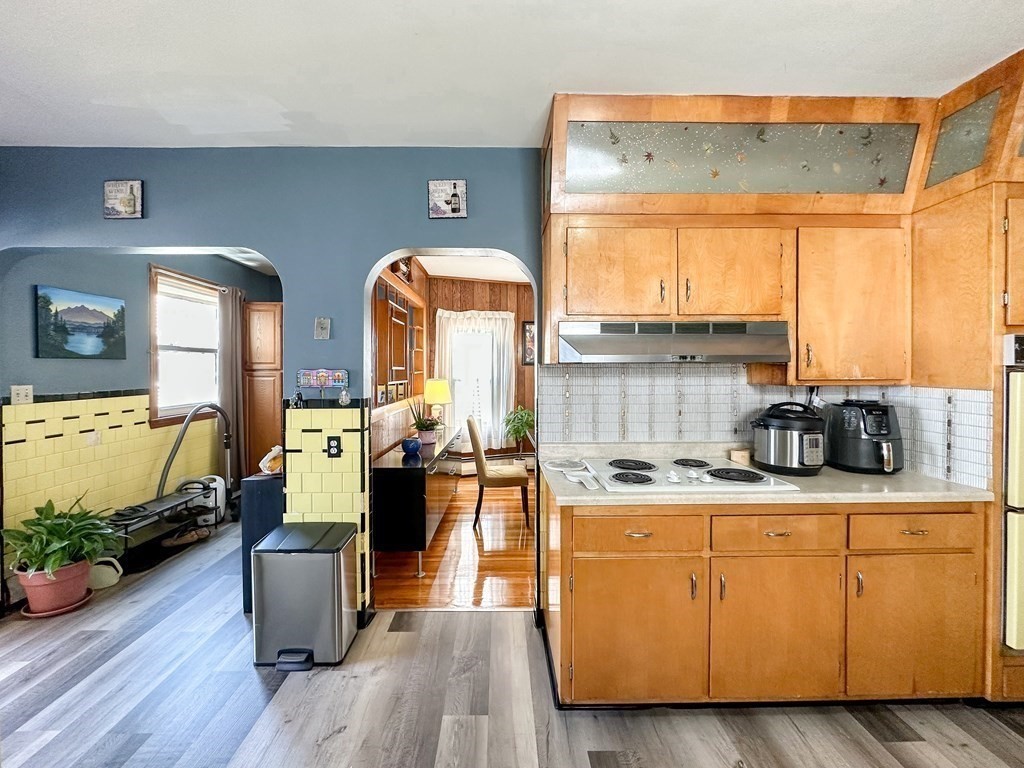 82 Jefferson Avenue Everett, MA 02149 - Photo 6 of 37 a view of kitchen with stainless steel appliances kitchen island granite countertop a stove a sink dishwasher and a dining table with wooden cabinet
