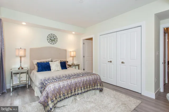 a bedroom with a bed and a lamp