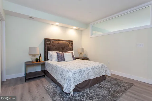 a bedroom with a bed and a painting on the wall