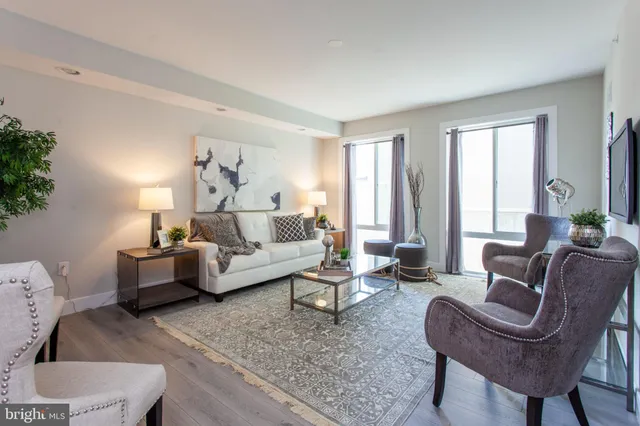 a living room with furniture and a large window