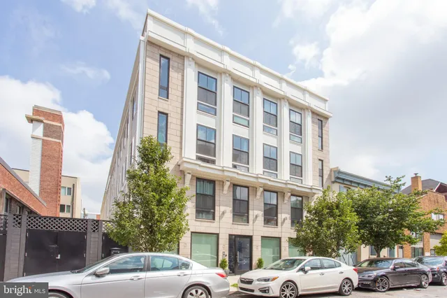 a couple of cars parked in front of a building