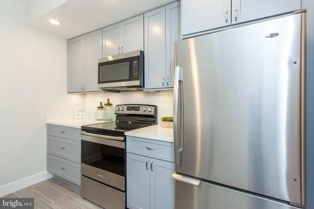 a kitchen with stainless steel appliances a refrigerator stove and sink