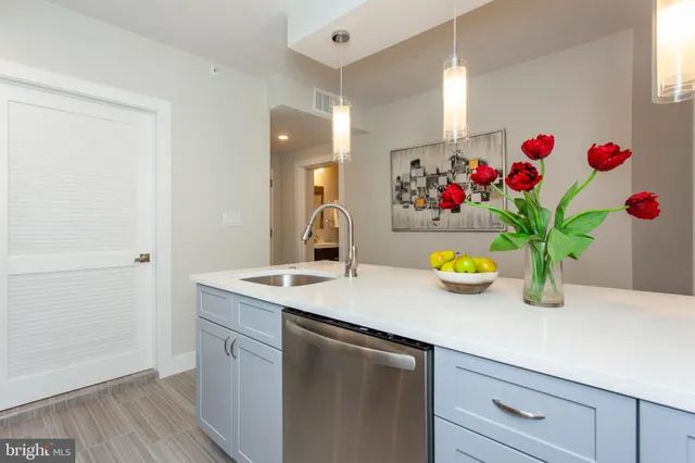 a view of a sink a counter space with wooden floor