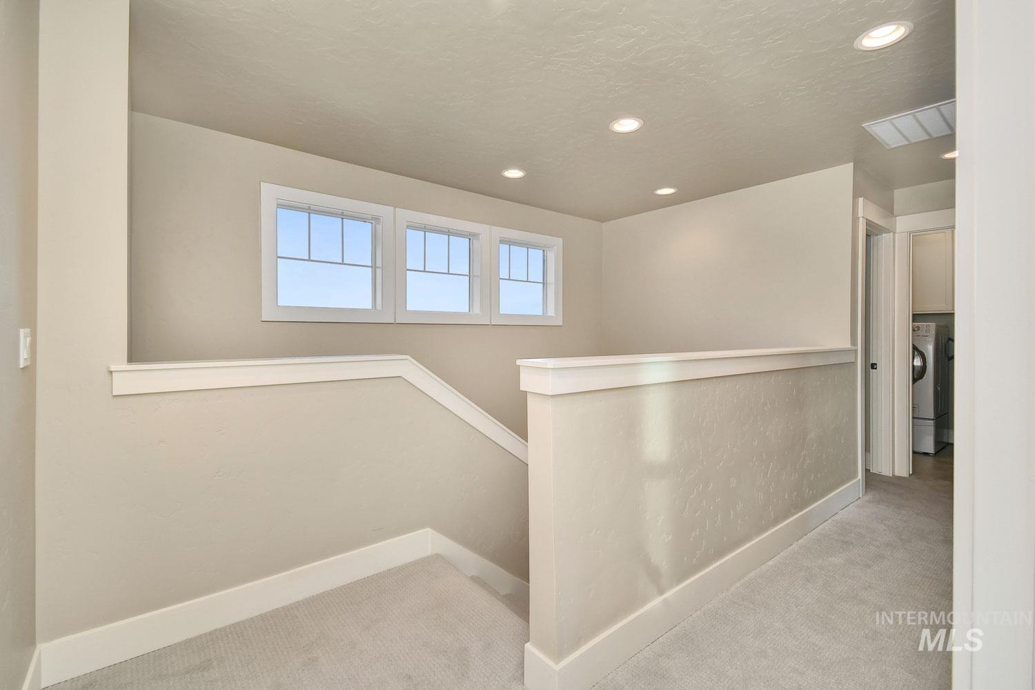 5771 West Daphne Drive Meridian, ID 83646 - Photo 17 of 32 Corridor with an upstairs landing, carpet flooring, recessed lighting, and washer / clothes dryer