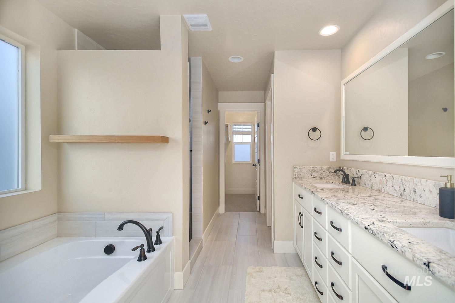 5771 West Daphne Drive Meridian, ID 83646 - Photo 20 of 32 Full bathroom featuring double vanity and a bath