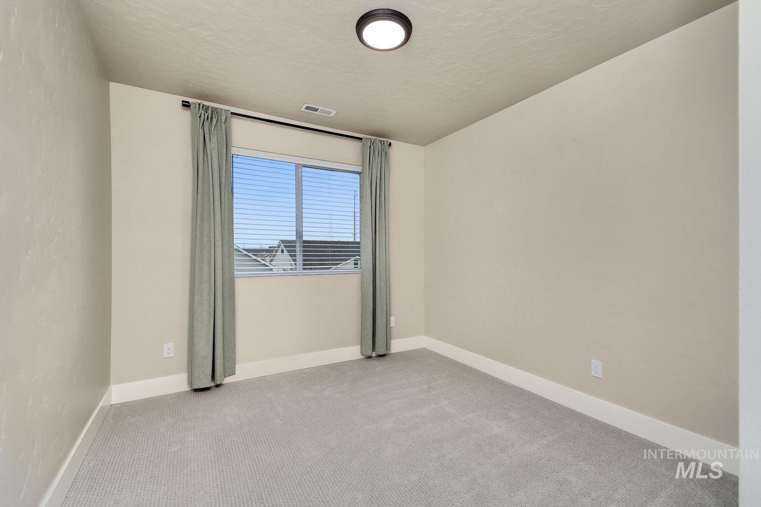 5771 West Daphne Drive Meridian, ID 83646 - Photo 24 of 32 Unfurnished room with carpet and a textured ceiling