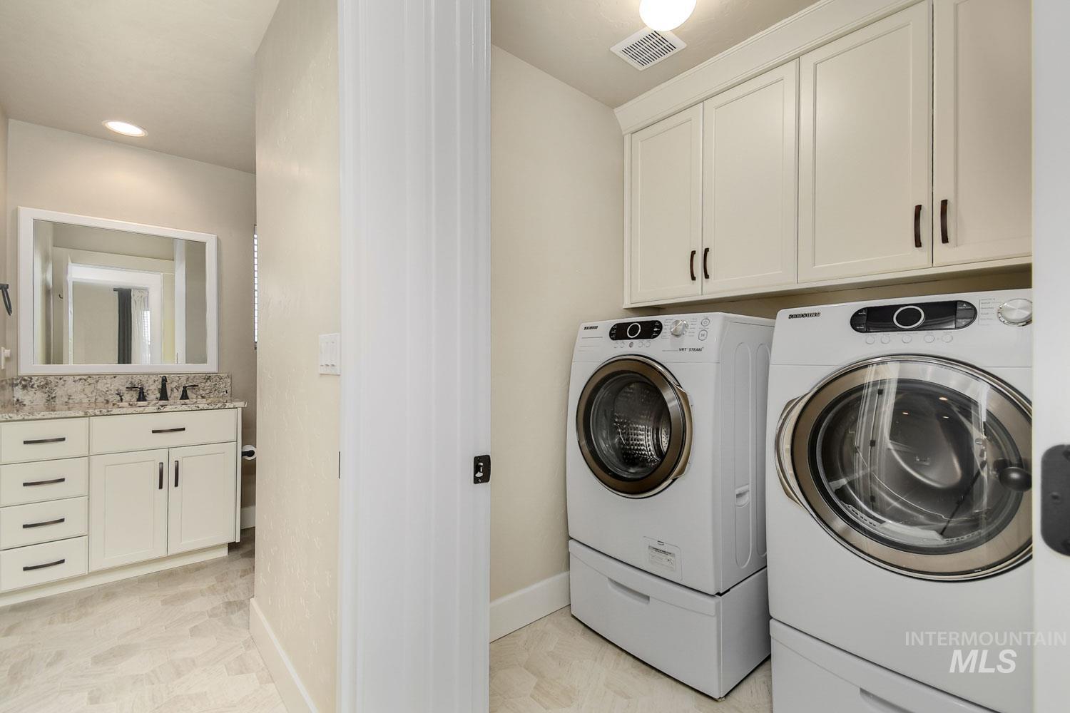 5771 West Daphne Drive Meridian, ID 83646 - Photo 26 of 32 Laundry room with cabinet space, washing machine and clothes dryer, and recessed lighting