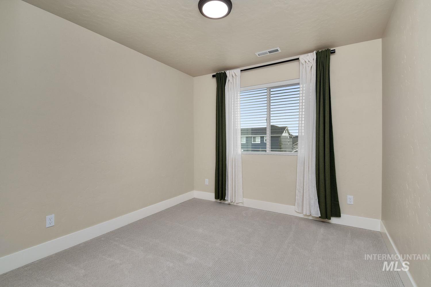 5771 West Daphne Drive Meridian, ID 83646 - Photo 28 of 32 Spare room featuring light colored carpet and baseboards
