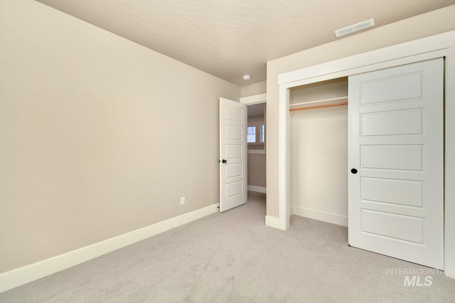 5771 West Daphne Drive Meridian, ID 83646 - Photo 29 of 32 Unfurnished bedroom with light carpet and a closet
