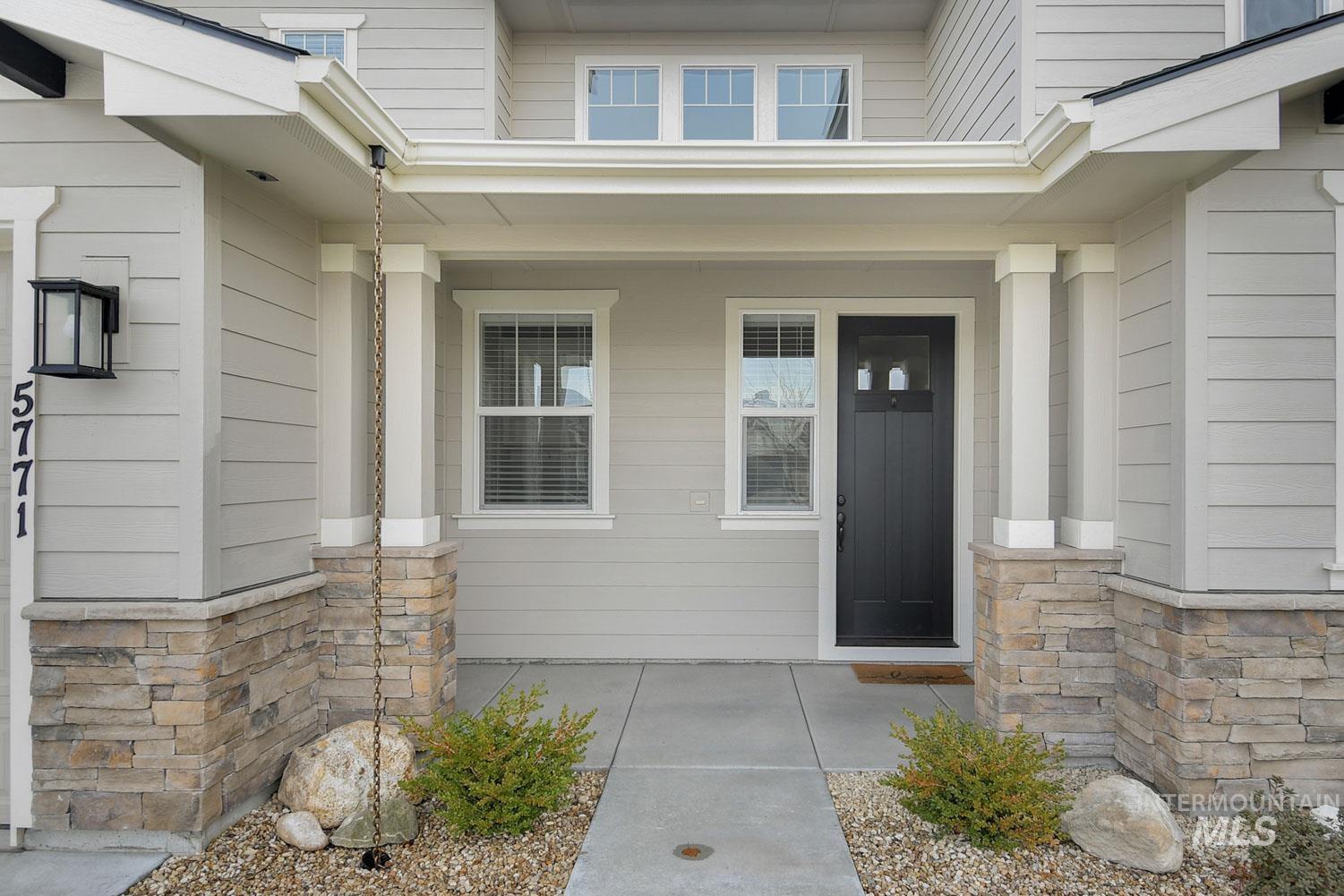 5771 West Daphne Drive Meridian, ID 83646 - Photo 3 of 32 View of exterior entry with a porch and stone siding