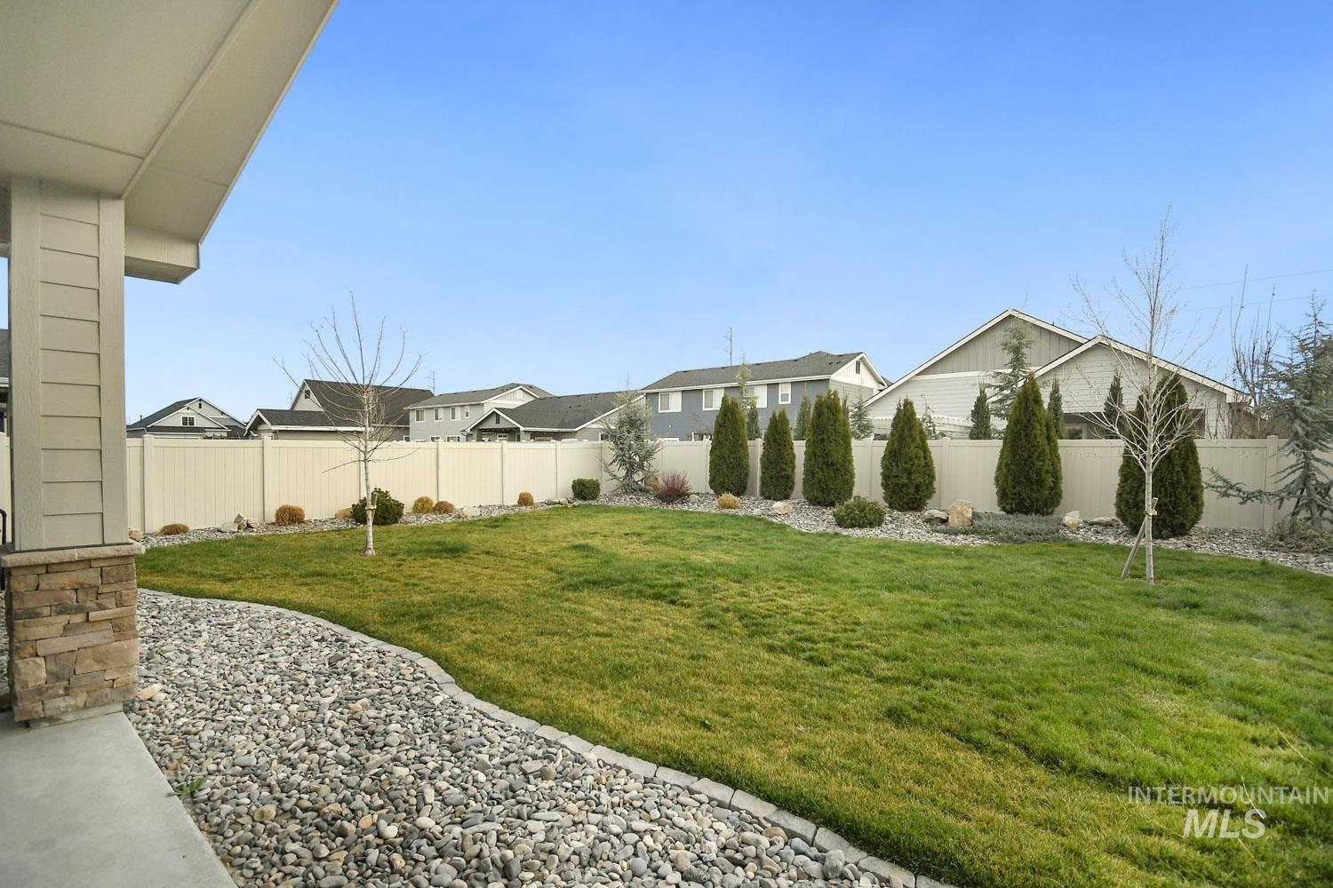 5771 West Daphne Drive Meridian, ID 83646 - Photo 31 of 32 Fenced backyard featuring a residential view and a patio area