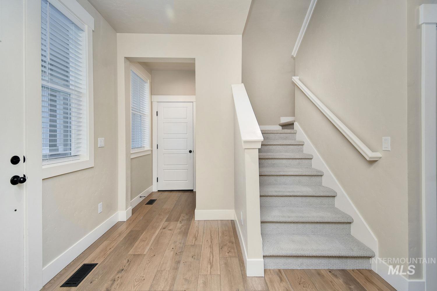 5771 West Daphne Drive Meridian, ID 83646 - Photo 4 of 32 Stairs with baseboards and wood finished floors