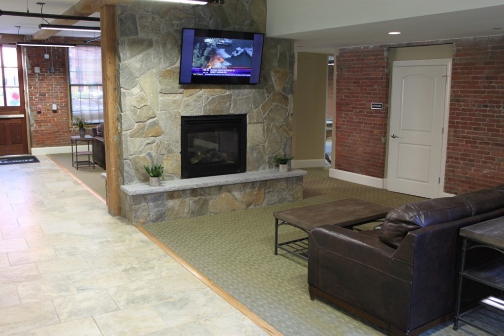 64 Beacon Street, Unit C105 Worcester, MA 01608 - Photo 15 of 23 a living room with furniture and a fireplace