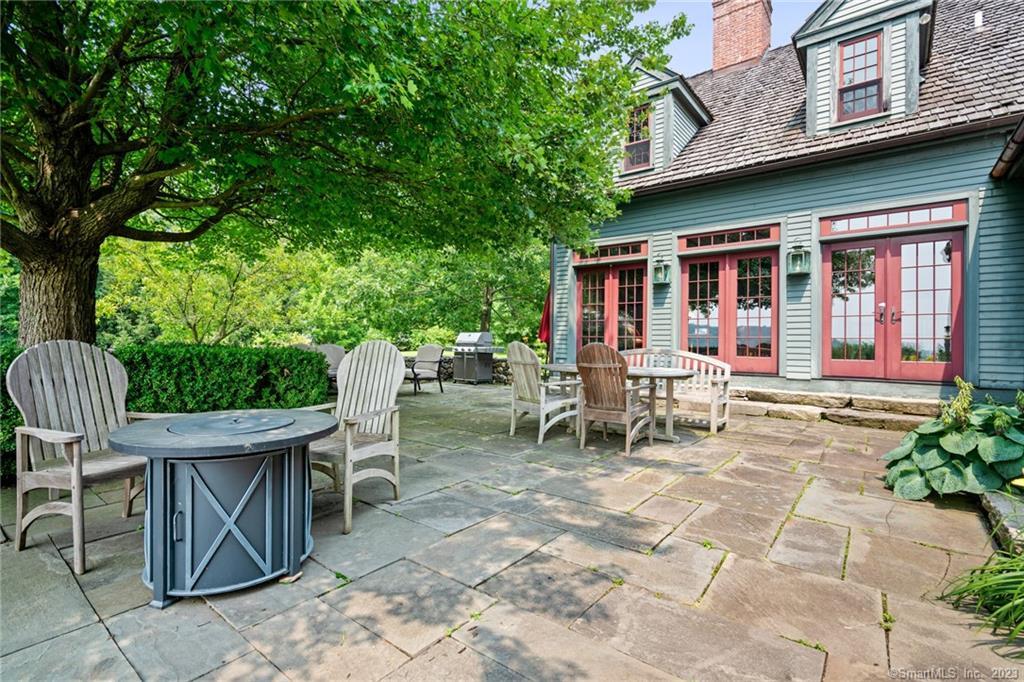 a view of a chairs and table in backyard of the house