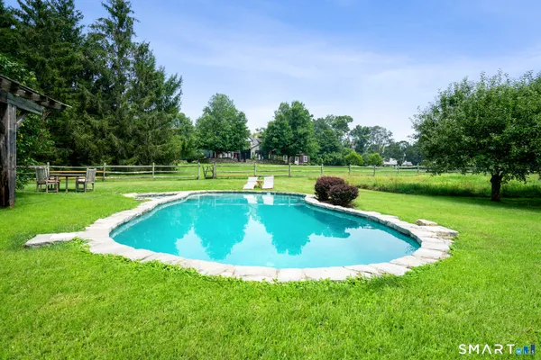 a view of a swimming pool and trees in the background