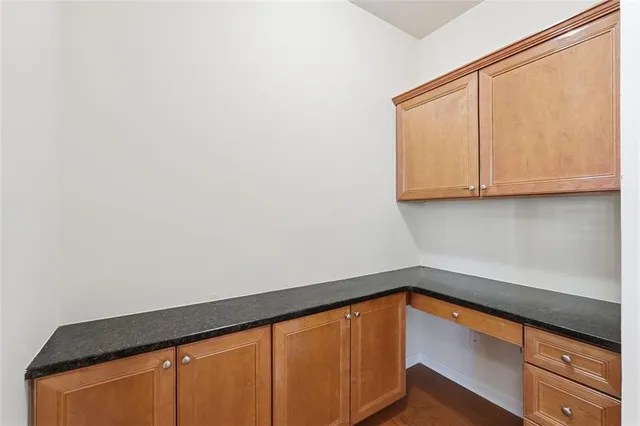 a bathroom with a granite countertop sink mirror and shower
