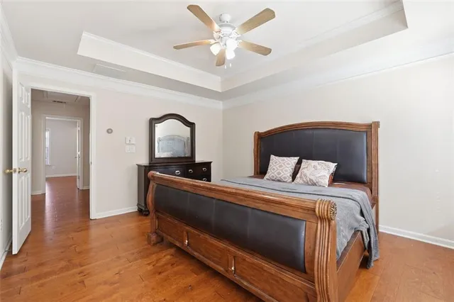 a bedroom with a large bed and a chandelier
