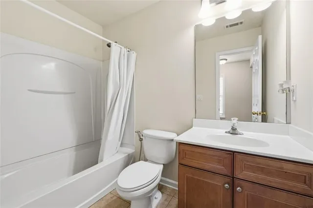a white bath tub sitting next to a toilet