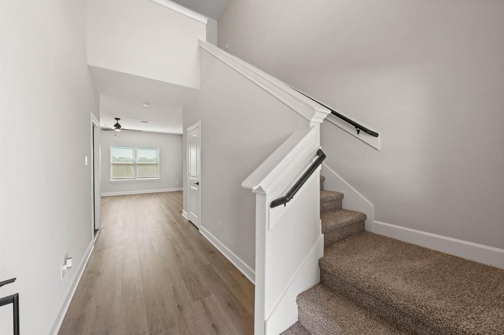 809 Princeton Hts Boulevard Princeton, TX 75407 - Photo 7 of 10 a view of a hallway with wooden floor and staircase