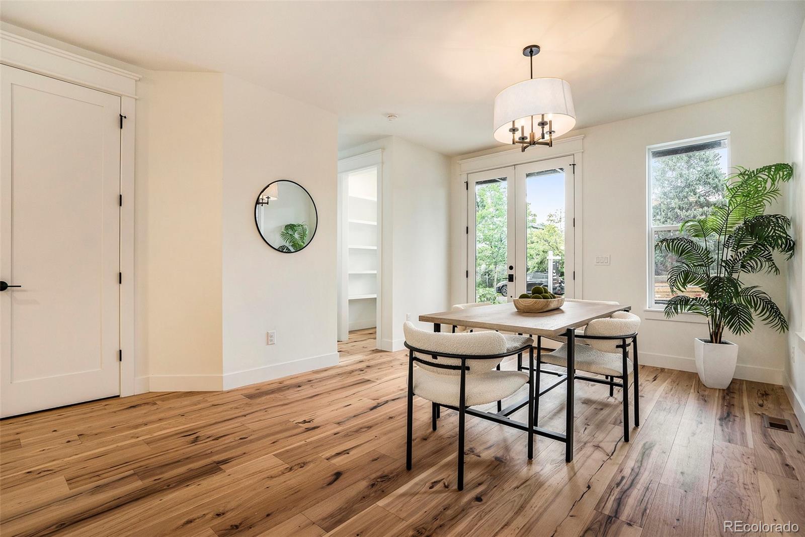 3271 Perry Street Denver, CO 80212 - Photo 12 of 34 a view of a dining room with furniture window and wooden floor