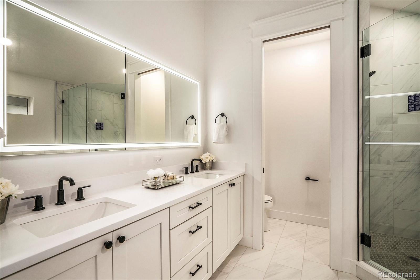 3271 Perry Street Denver, CO 80212 - Photo 17 of 34 a bathroom with a double vanity sink mirror and shower
