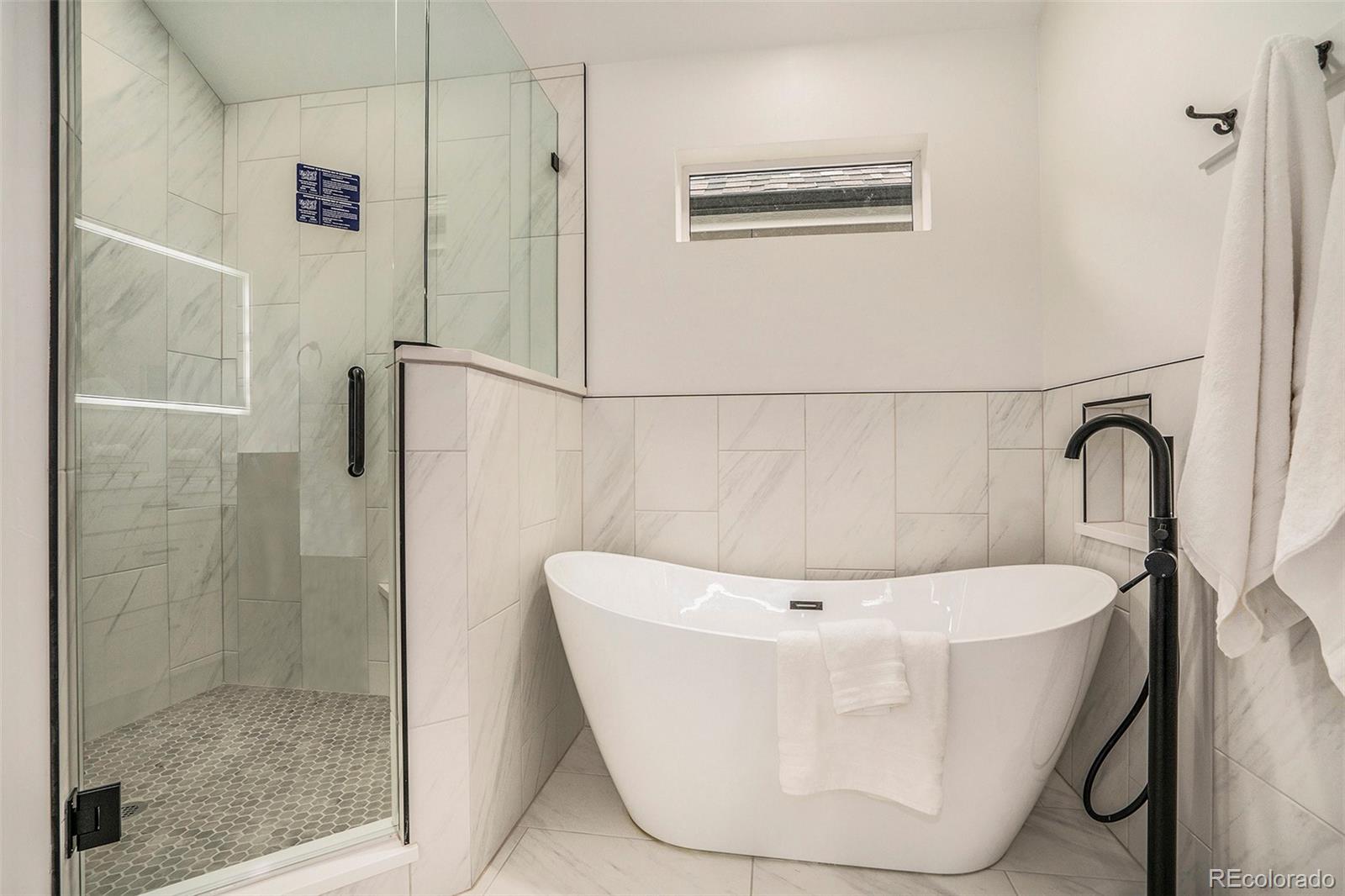 3271 Perry Street Denver, CO 80212 - Photo 18 of 34 a white bath tub sitting in a bathroom