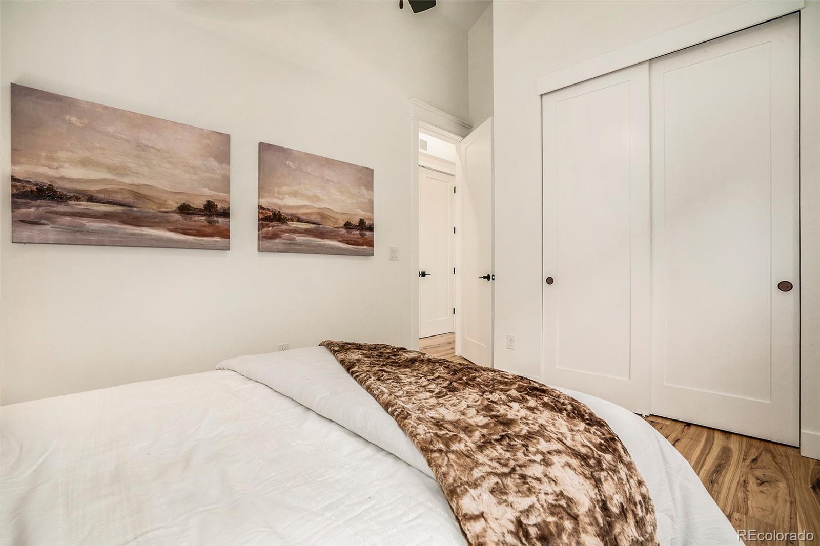 3271 Perry Street Denver, CO 80212 - Photo 20 of 34 a bedroom with a bed and a painting on the wall