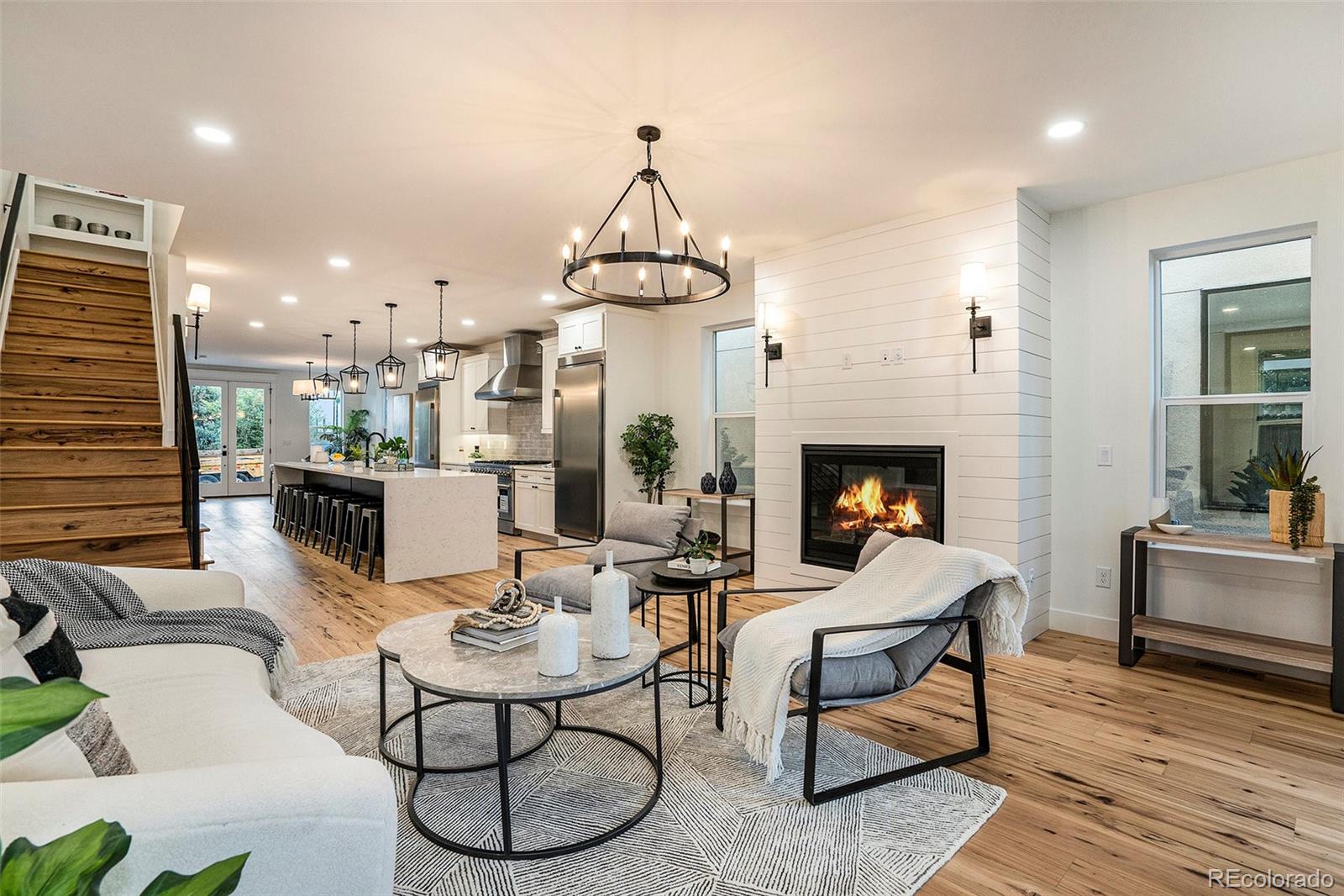 3271 Perry Street Denver, CO 80212 - Photo 2 of 34 a living room with fireplace furniture dining table and a fireplace