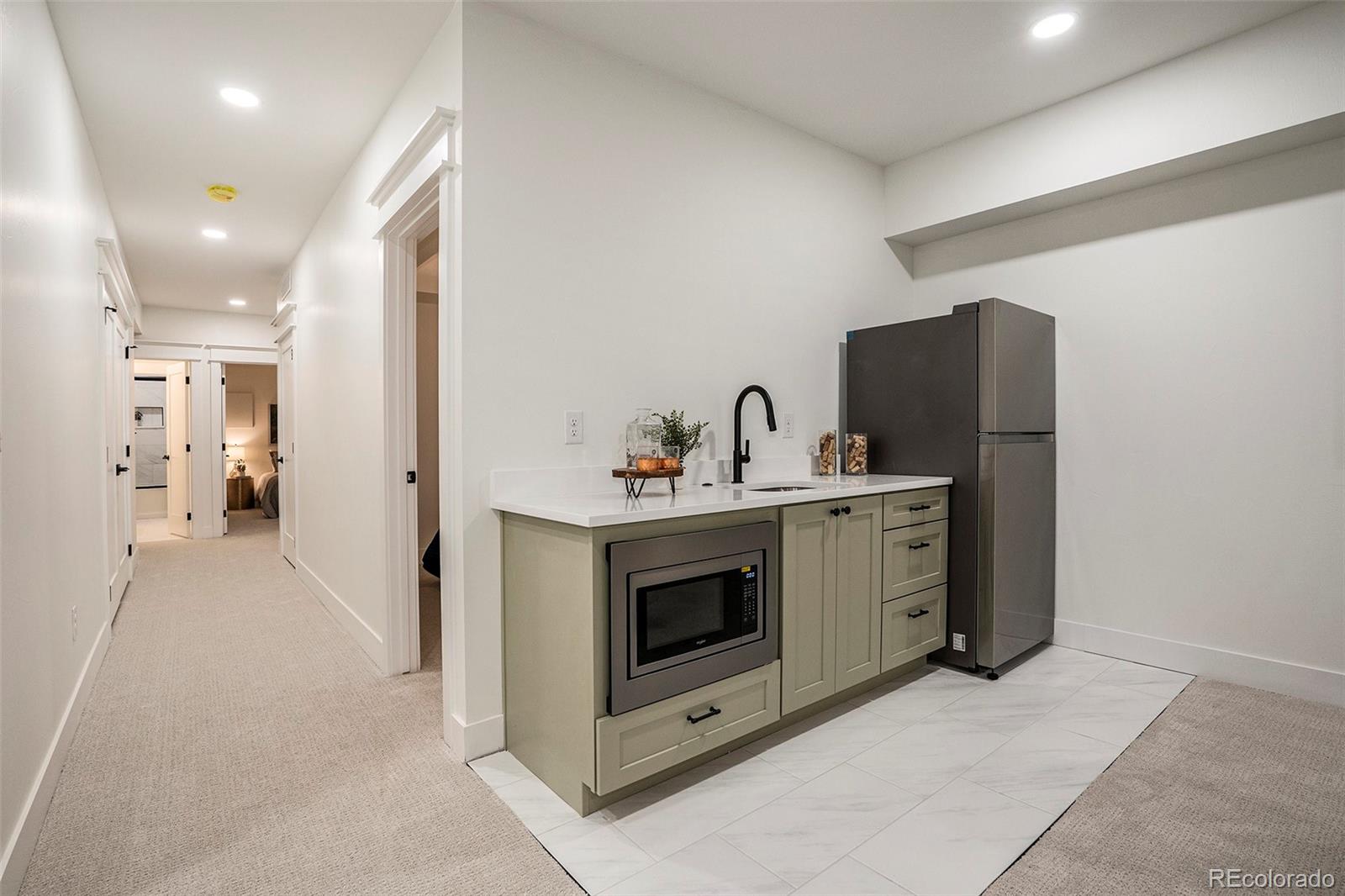 3271 Perry Street Denver, CO 80212 - Photo 27 of 34 a view of a kitchen with refrigerator and white cabinets