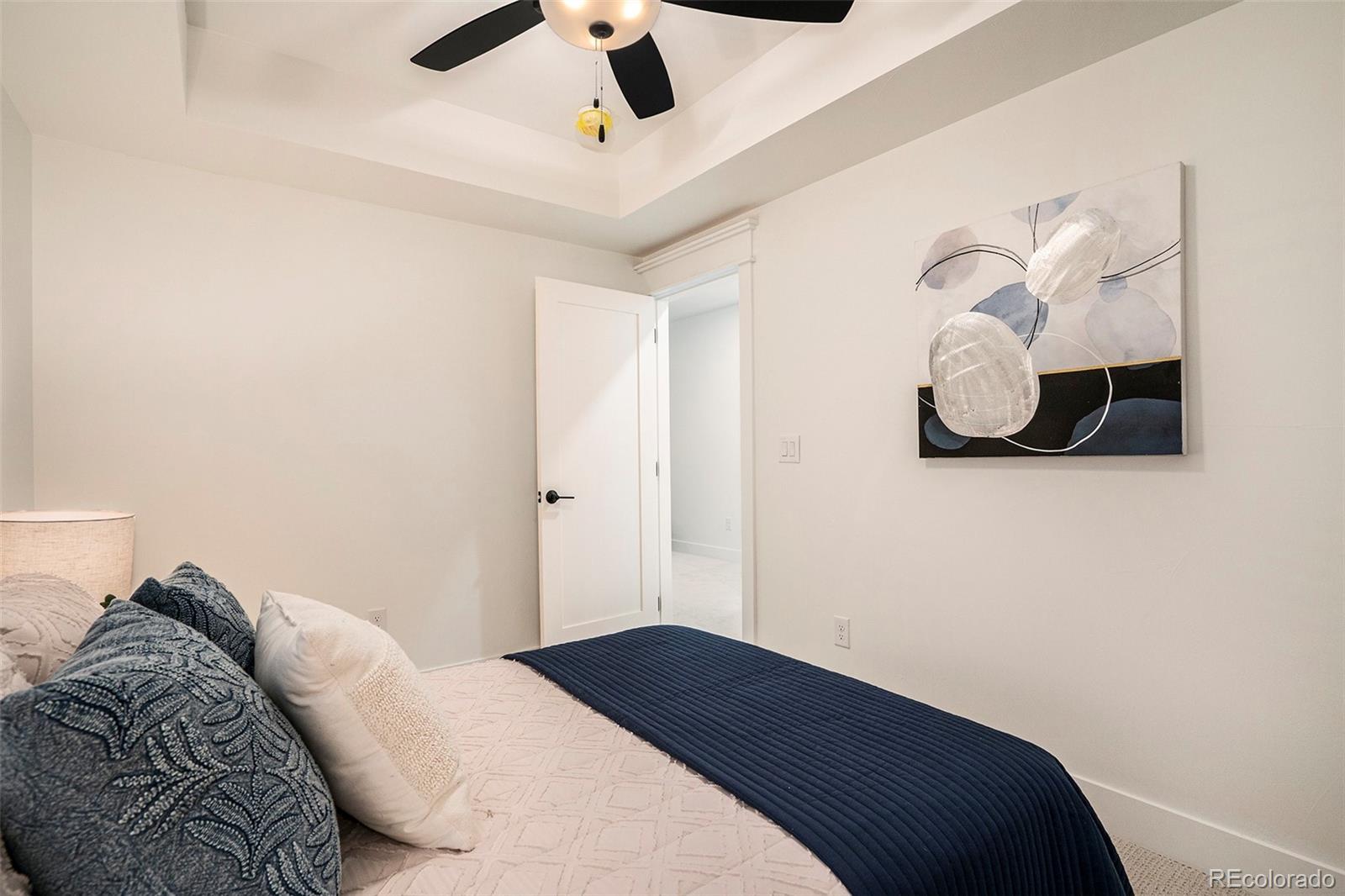 3271 Perry Street Denver, CO 80212 - Photo 29 of 34 a bedroom with a bed and a chandelier