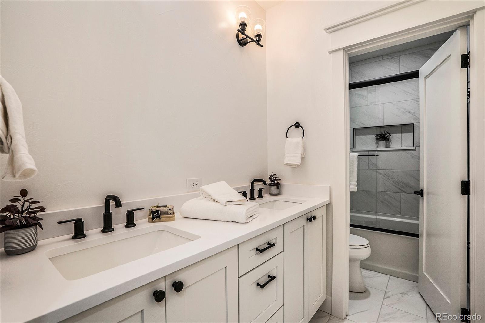3271 Perry Street Denver, CO 80212 - Photo 30 of 34 a bathroom with a sink vanity and mirror