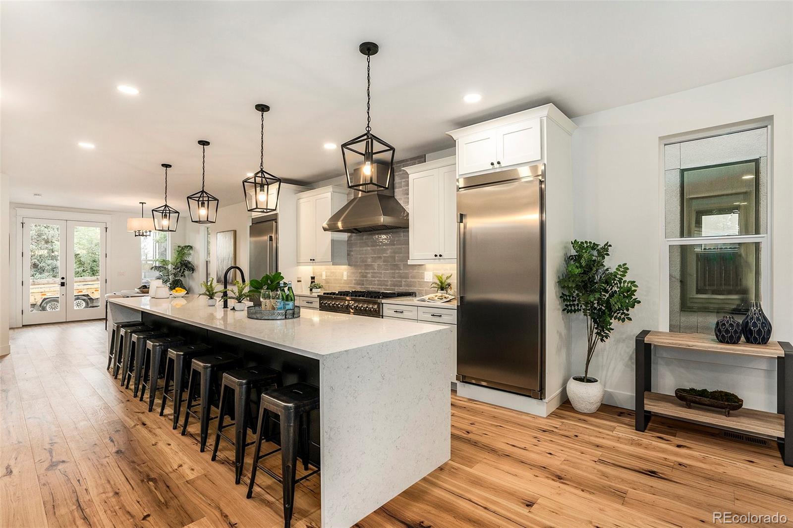 3271 Perry Street Denver, CO 80212 - Photo 7 of 34 a kitchen with kitchen island a counter top space a sink appliances and cabinets
