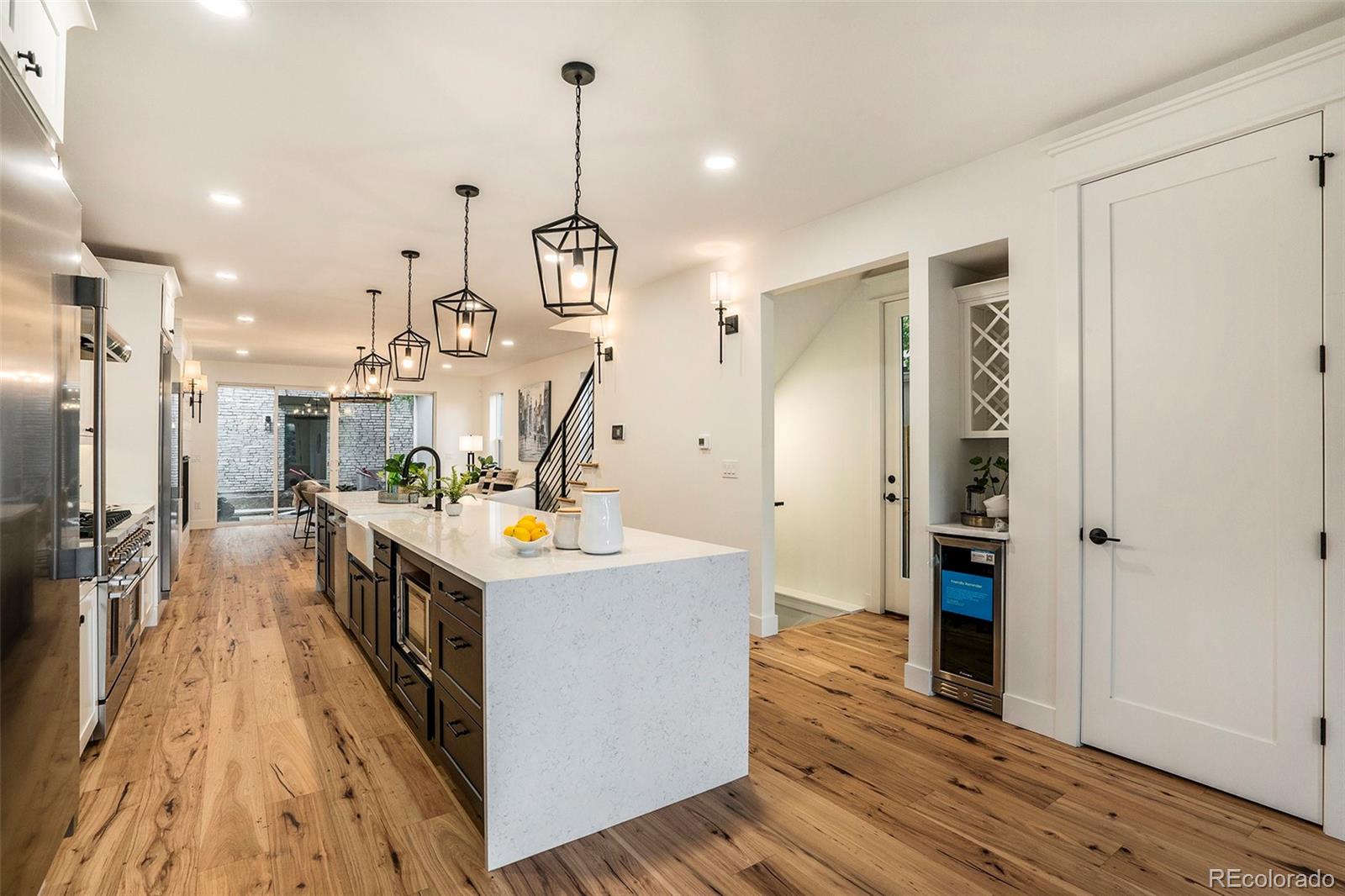 3271 Perry Street Denver, CO 80212 - Photo 8 of 34 a kitchen that has a lot of cabinets and wooden floor