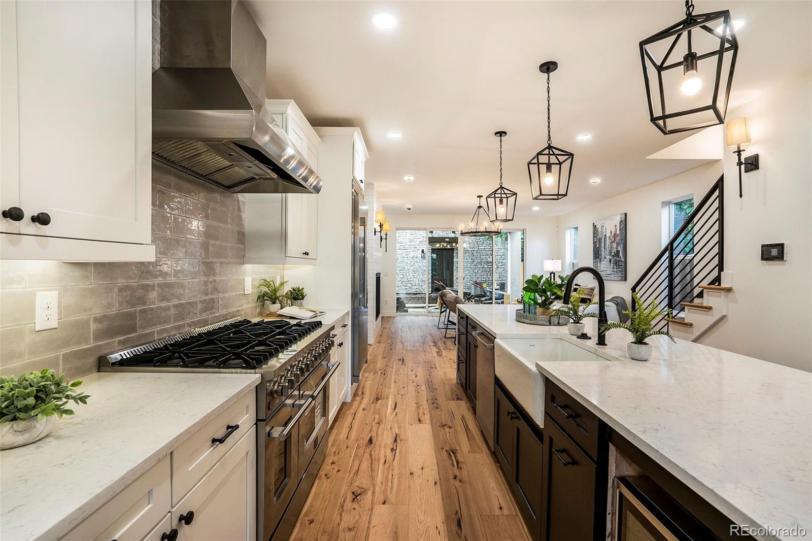 3271 Perry Street Denver, CO 80212 - Photo 10 of 34 a kitchen with stainless steel appliances a sink a stove oven a counter space and cabinets