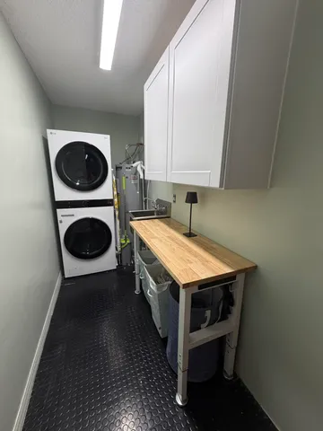 a view of backyard with table and chairs and potted plants