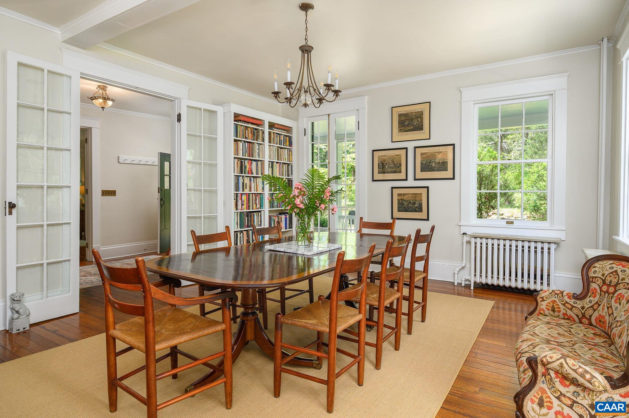 1326 Rugby Road Charlottesville, VA 22903 - Photo 13 of 65 a dining room with furniture chandelier and wooden floor
