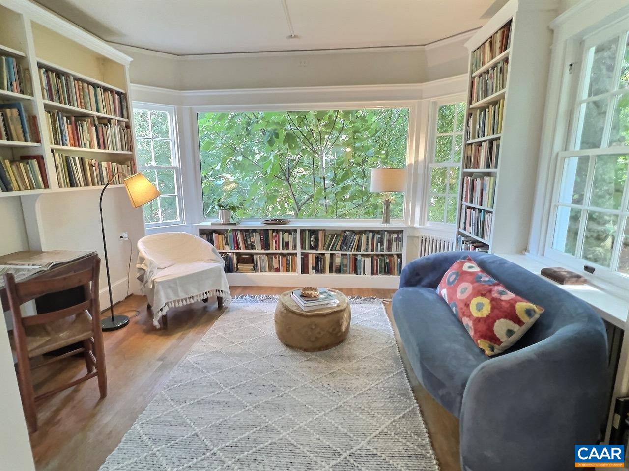 1326 Rugby Road Charlottesville, VA 22903 - Photo 20 of 65 a living room with furniture and a floor to ceiling window