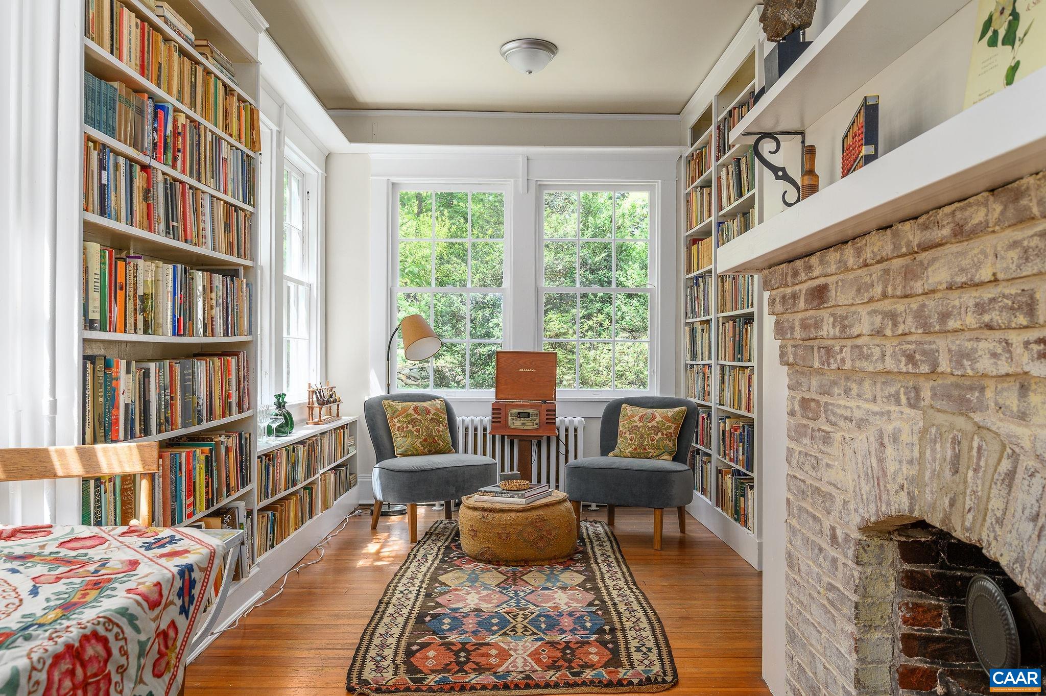 1326 Rugby Road Charlottesville, VA 22903 - Photo 21 of 65 a living room with furniture and a book shelf