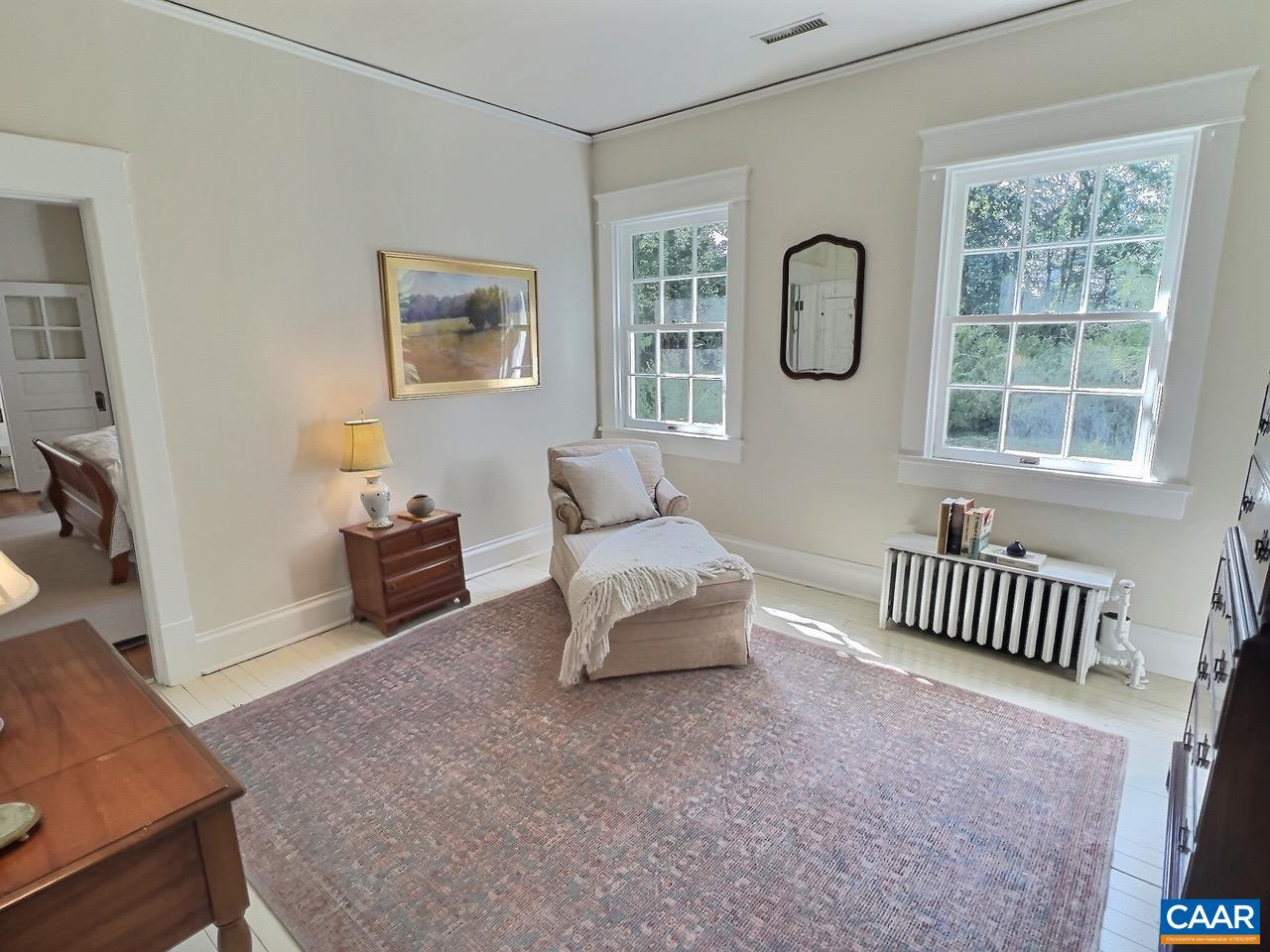 1326 Rugby Road Charlottesville, VA 22903 - Photo 26 of 65 a spacious bedroom with a bed and a couch