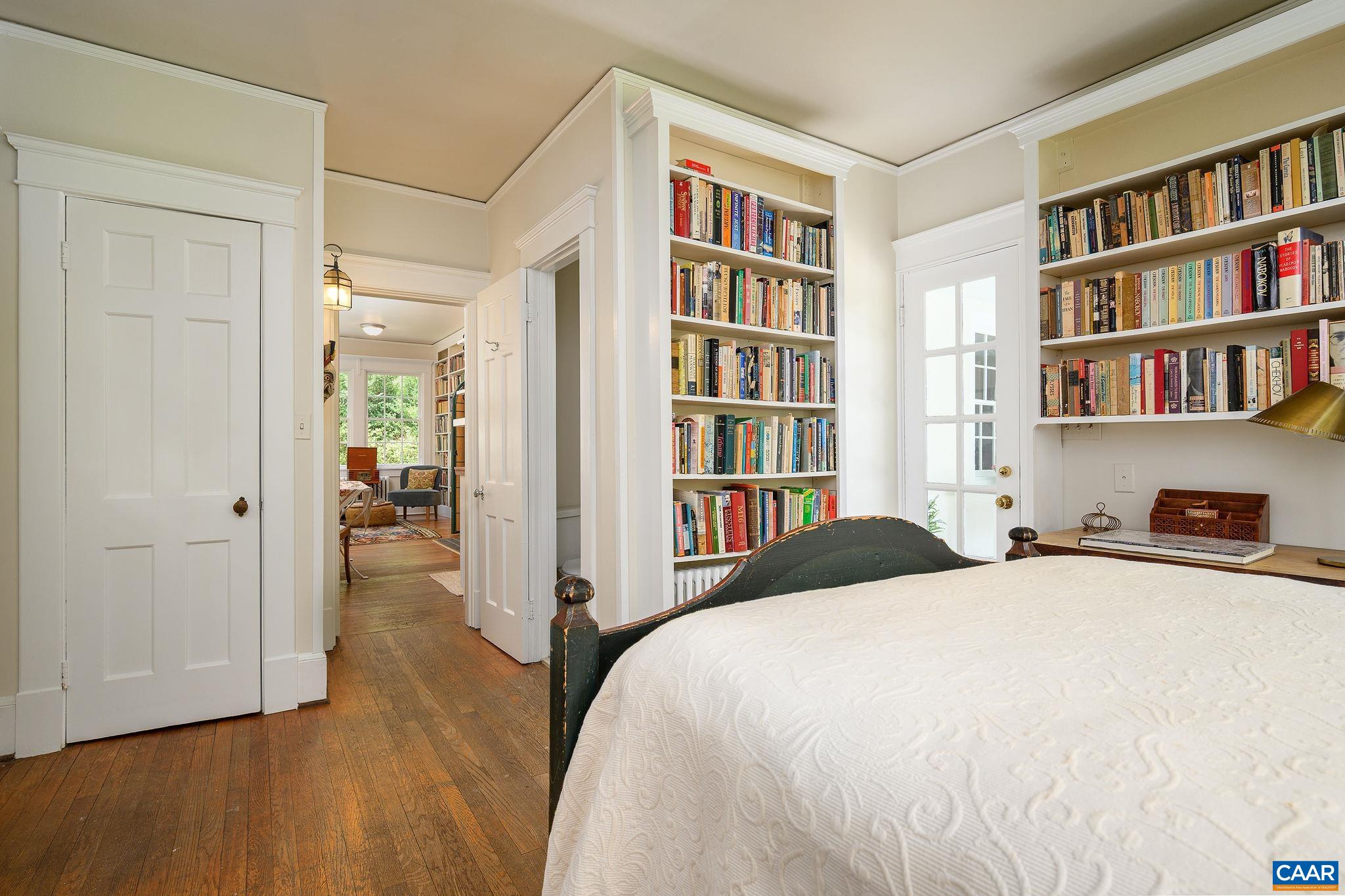 1326 Rugby Road Charlottesville, VA 22903 - Photo 27 of 65 a bedroom with a bed and a book shelf