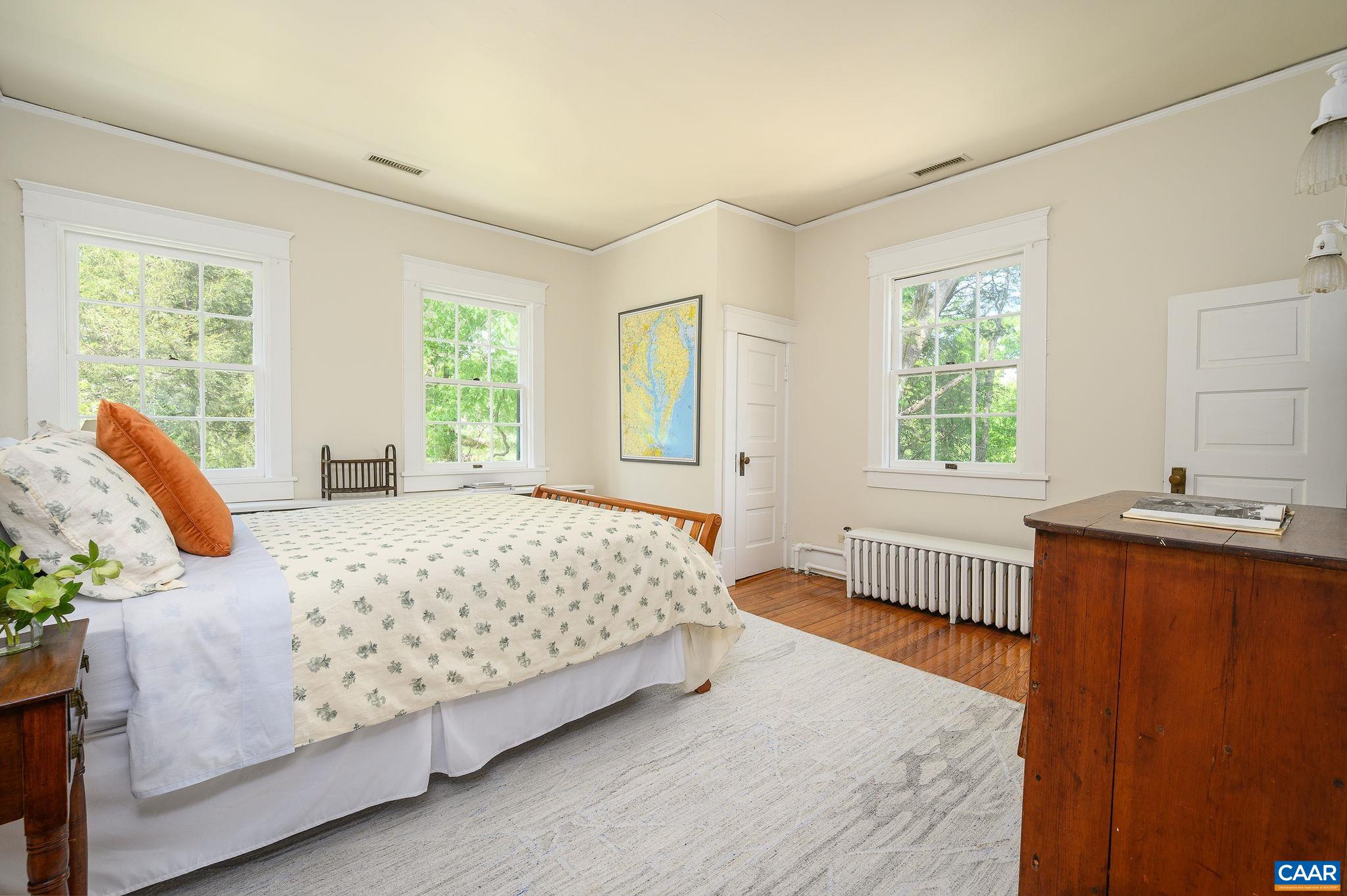 1326 Rugby Road Charlottesville, VA 22903 - Photo 29 of 65 a bedroom with a bed and wooden floor
