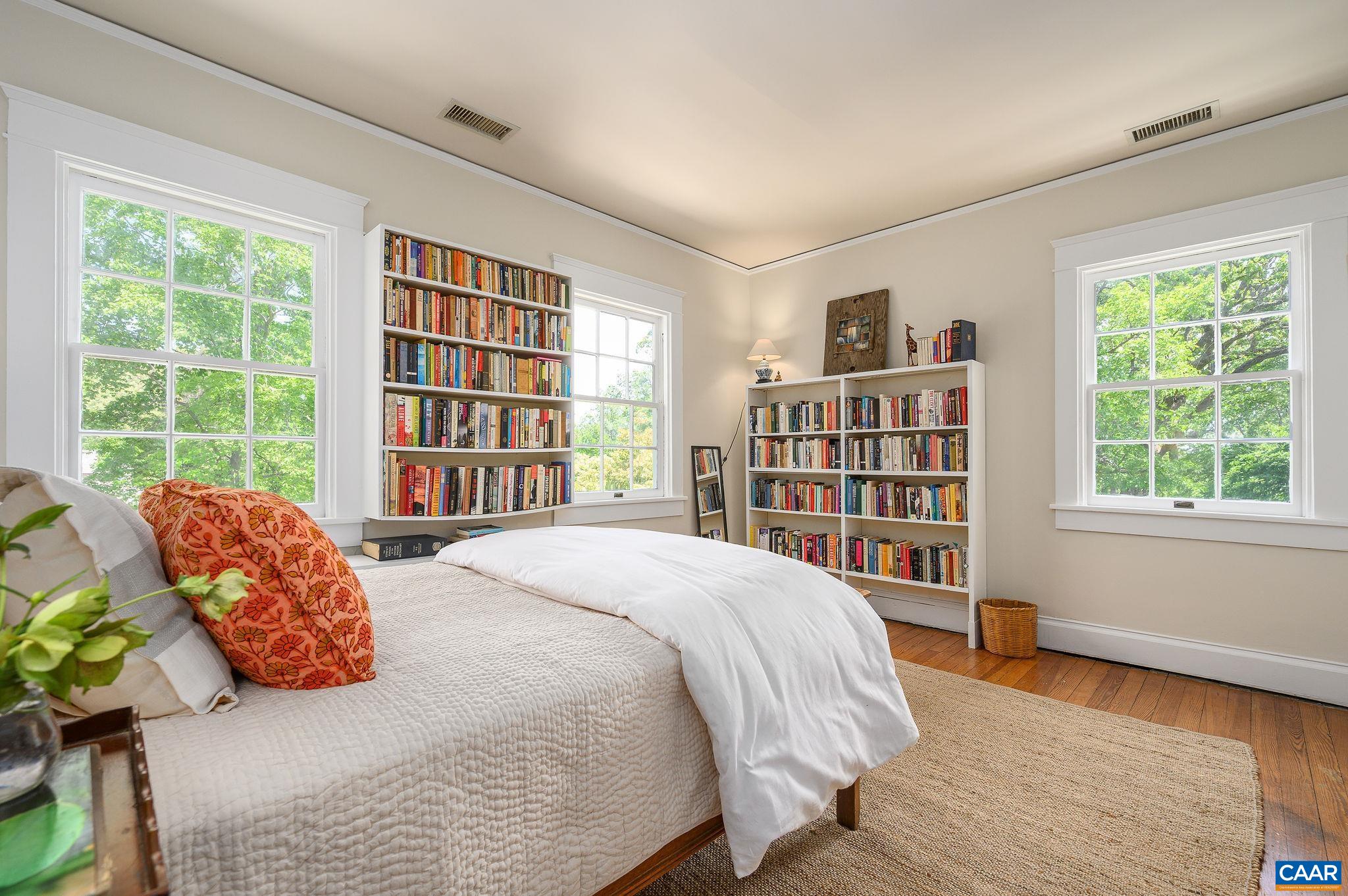 1326 Rugby Road Charlottesville, VA 22903 - Photo 30 of 65 a spacious bedroom with a bed and a large window with the outer view