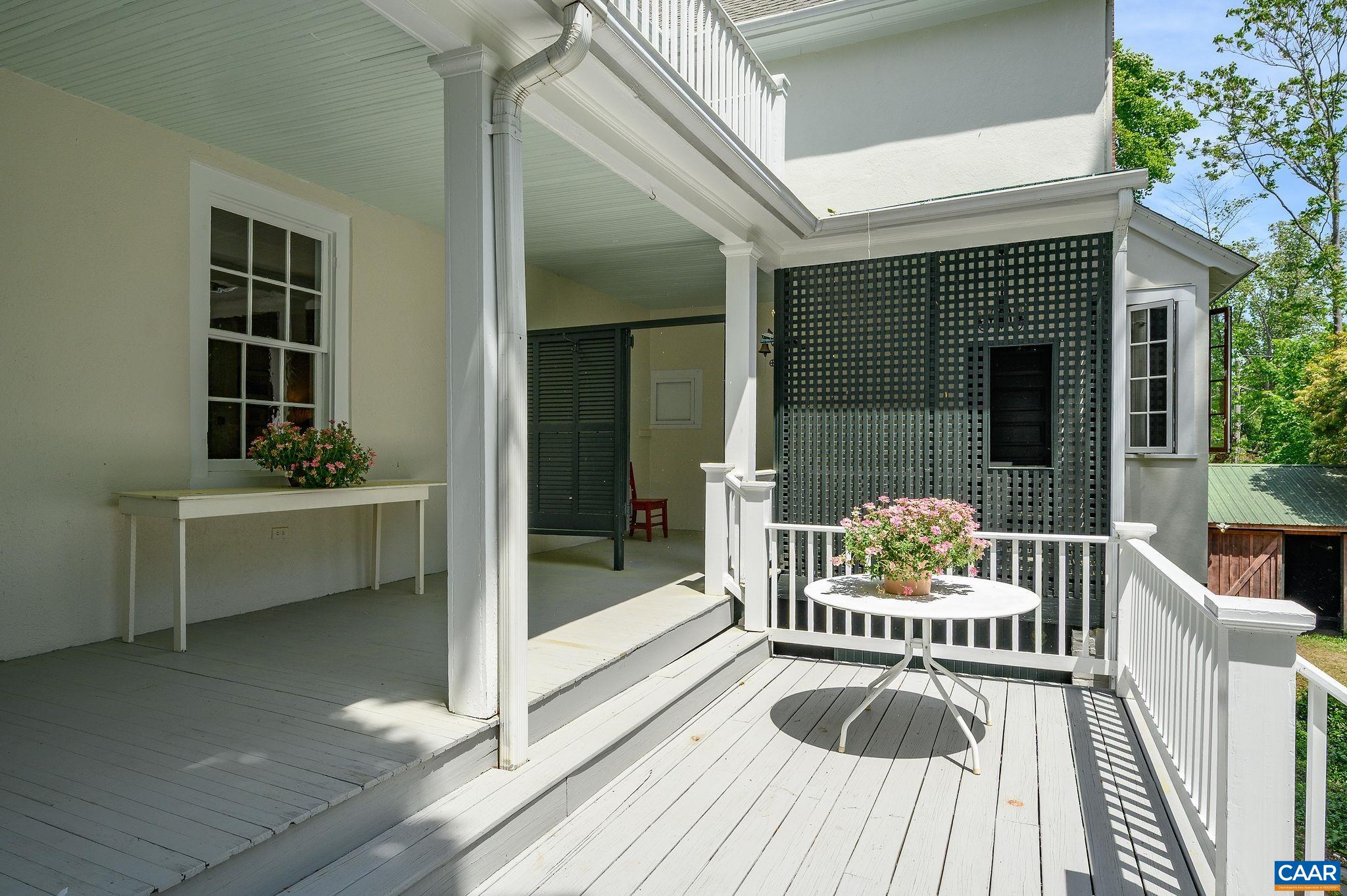 1326 Rugby Road Charlottesville, VA 22903 - Photo 38 of 65 a balcony with furniture and a potted plant