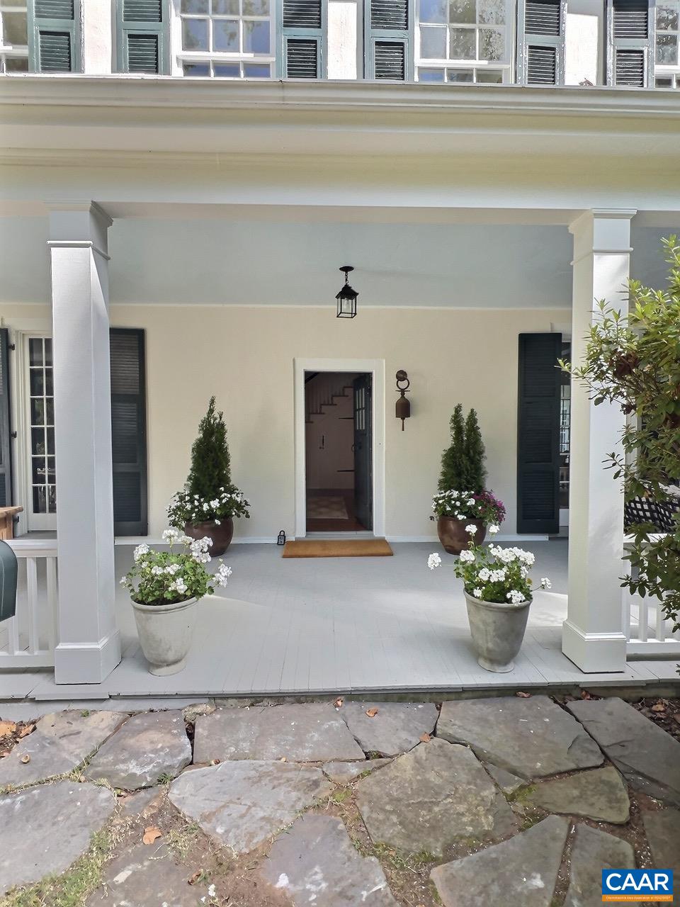 1326 Rugby Road Charlottesville, VA 22903 - Photo 4 of 65 a front view of a house with lots of potted plants