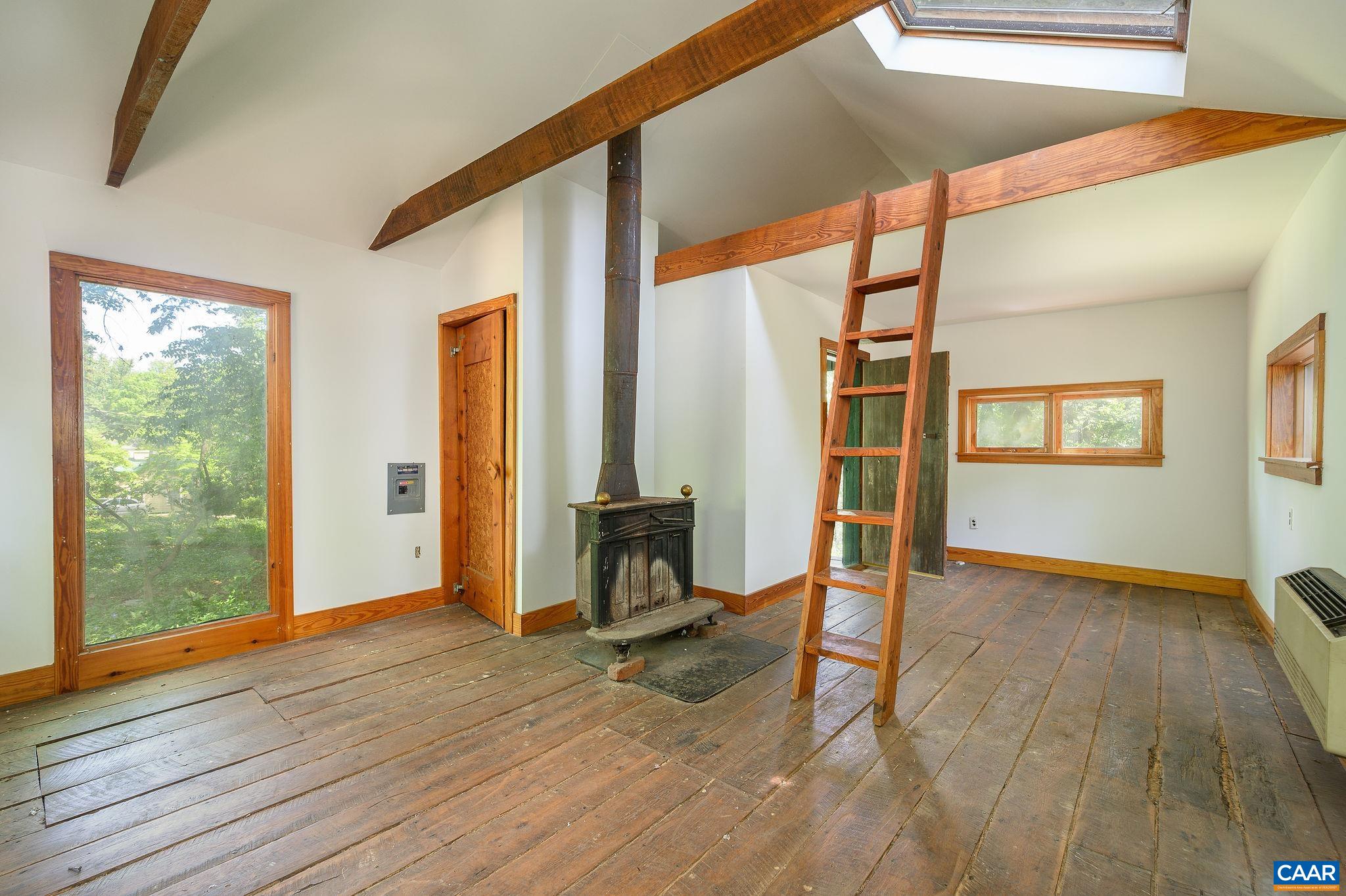 1326 Rugby Road Charlottesville, VA 22903 - Photo 60 of 65 a view of an empty room with glass door and wooden floor