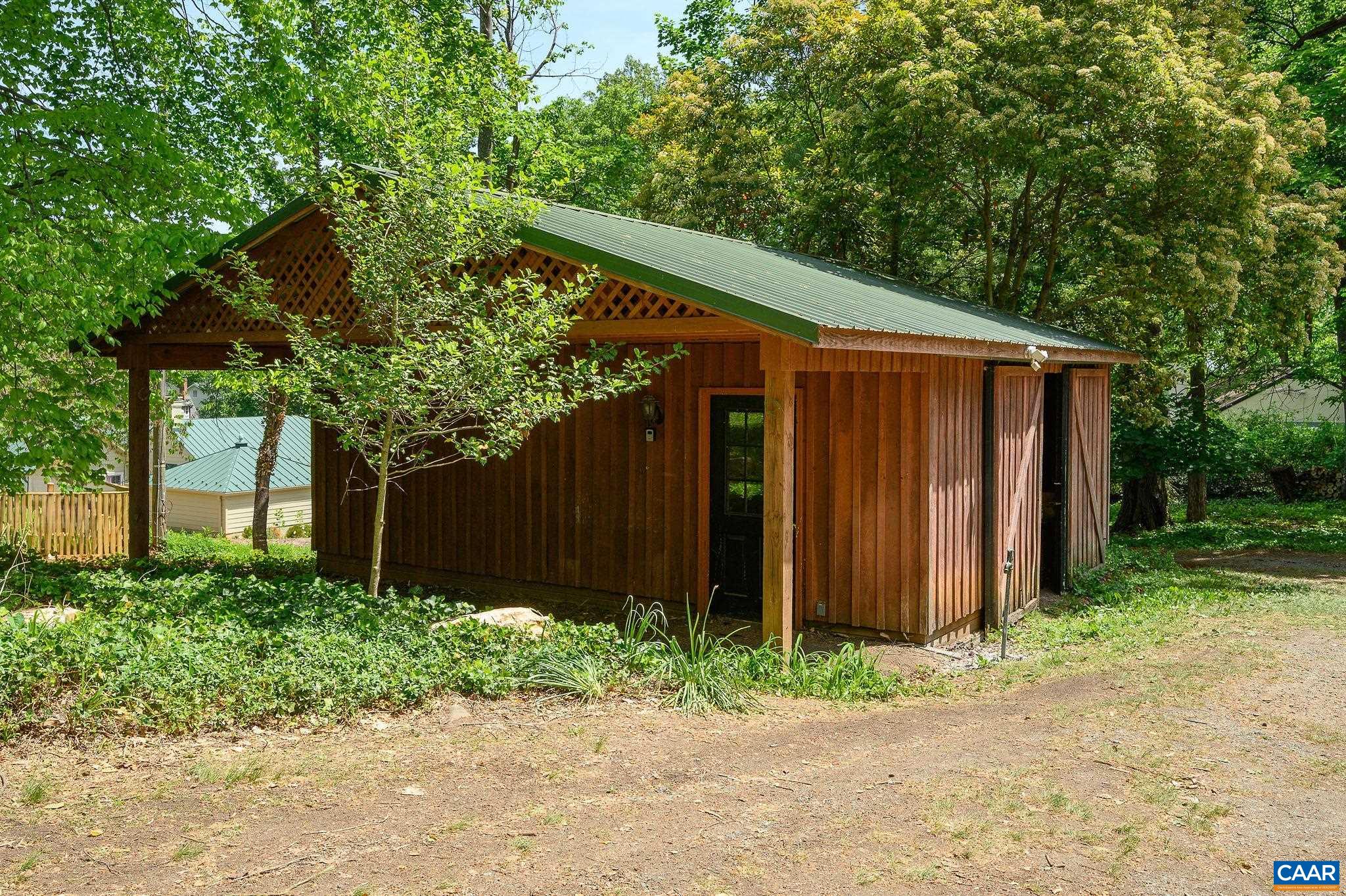 1326 Rugby Road Charlottesville, VA 22903 - Photo 65 of 65 a backyard of a house with plants and trees with wooden fence