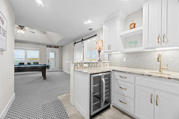 a view of a room with furniture and wooden floor